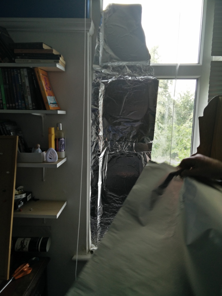 Covering the window with foil to make it appear like nighttime